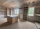 Unfinished dressing room with custom shelves and a work island at 839 Braselton Hwy, Lawrenceville, GA 30043