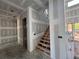 Open entryway featuring an unfinished wooden staircase, awaiting final touches at 839 Braselton Hwy, Lawrenceville, GA 30043