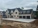 New home features light-colored brick, dark window frames, and a convenient three-car garage at 839 Braselton Hwy, Lawrenceville, GA 30043