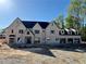 Elegant home with brick facade, gabled roof, and three-car garage awaiting its finishing touches at 839 Braselton Hwy, Lawrenceville, GA 30043