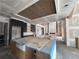 Open concept kitchen includes a decorative ceiling and a large island with a farmhouse sink at 839 Braselton Hwy, Lawrenceville, GA 30043