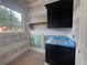 The unfinished laundry room offers black lower cabinets, a sink, and a window at 839 Braselton Hwy, Lawrenceville, GA 30043