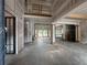 Unfinished living room with high ceilings, large windows overlooking the backyard and pool at 839 Braselton Hwy, Lawrenceville, GA 30043
