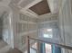 Second story living room featuring a tray ceiling, large windows, and unfinished walls at 839 Braselton Hwy, Lawrenceville, GA 30043
