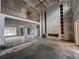 Unfinished living room features a statement fireplace, two-story ceilings, and an open-concept design at 839 Braselton Hwy, Lawrenceville, GA 30043