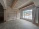 Unfinished living room showcases a modern accent wall and large window with natural light at 839 Braselton Hwy, Lawrenceville, GA 30043