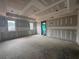 Unfinished living room with windows allowing natural light and a door leading to the outdoors at 839 Braselton Hwy, Lawrenceville, GA 30043