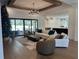 Open living room with hardwood floors, large windows, and modern decor near a pool at 839 Braselton Hwy, Lawrenceville, GA 30043