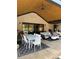 Covered outdoor living area with comfortable seating, dining table and fan at 839 Braselton Hwy, Lawrenceville, GA 30043