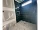 New shower installation featuring teal tile and a marble shower floor, ready to be finished at 839 Braselton Hwy, Lawrenceville, GA 30043