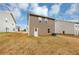 Brown siding home with a small, grassy backyard at 518 Firethorn Ct, Villa Rica, GA 30180