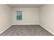 Spacious bedroom with gray carpet and a window at 518 Firethorn Ct, Villa Rica, GA 30180