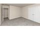 Well-lit bedroom with grey carpet and double doors to closet at 518 Firethorn Ct, Villa Rica, GA 30180