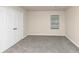 Simple bedroom with carpet, double door closet, and window with blinds at 518 Firethorn Ct, Villa Rica, GA 30180