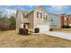 Two-story house with brick and siding, two-car garage, and landscaping at 518 Firethorn Ct, Villa Rica, GA 30180