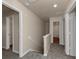 Upstairs hallway with carpet and access to bedrooms and bathroom at 518 Firethorn Ct, Villa Rica, GA 30180