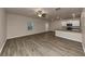 Open living room and kitchen with wood-look floors and ceiling fan at 518 Firethorn Ct, Villa Rica, GA 30180