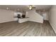 Open living room and kitchen with wood-look floors and ceiling fan at 518 Firethorn Ct, Villa Rica, GA 30180