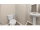 Small half bathroom with pedestal sink and wood-look flooring at 518 Firethorn Ct, Villa Rica, GA 30180
