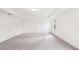 Bright bedroom with neutral carpet, tray ceiling, and a single window at 7260 Eton Ln, Locust Grove, GA 30248
