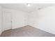 Bedroom with neutral carpet, two doors, and a ceiling light fixture at 7260 Eton Ln, Locust Grove, GA 30248