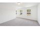 Bright bedroom with two windows providing natural light and neutral carpet at 7260 Eton Ln, Locust Grove, GA 30248