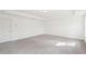 Spacious bedroom with neutral carpet, tray ceiling, and a window at 7260 Eton Ln, Locust Grove, GA 30248
