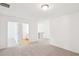 Bedroom featuring neutral carpet with adjacent rooms and a staircase visible at 7260 Eton Ln, Locust Grove, GA 30248