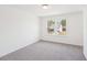 Bedroom with a large window bringing in natural light and a neutral carpet at 7260 Eton Ln, Locust Grove, GA 30248