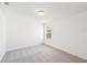A simple, clean bedroom with neutral carpet, white walls and a single window at 7260 Eton Ln, Locust Grove, GA 30248