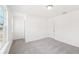 Bright bedroom featuring neutral carpet, white walls, and a ceiling light at 7260 Eton Ln, Locust Grove, GA 30248