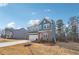 Charming two-story home with blue siding, stone accents, attached garage, and well-maintained landscaping at 7260 Eton Ln, Locust Grove, GA 30248