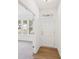 Inviting foyer with a white front door, wood floors, and views into the adjacent carpeted living room at 7260 Eton Ln, Locust Grove, GA 30248