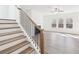 Sunlit living room showcasing staircase, fireplace, and windows with views at 7260 Eton Ln, Locust Grove, GA 30248