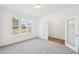 Bright, carpeted room with double doors and a large window offering plenty of natural light at 7260 Eton Ln, Locust Grove, GA 30248