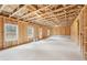 A large unfinished basement with exposed trusses and many windows at 7260 Eton Ln, Locust Grove, GA 30248