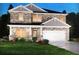 Two-story house with stone accents and a two-car garage at 7753 Plymouth Dr, Fairburn, GA 30213