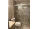 This bathroom features tiled walls, updated glass shower, toilet and sink at 3557 Clubhouse Ln, Conyers, GA 30094