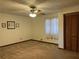 This bedroom features neutral carpeting, a ceiling fan, closet, and decorative touches at 3557 Clubhouse Ln, Conyers, GA 30094