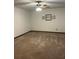 This bedroom features neutral carpeting, a ceiling fan, and decorative touches at 3557 Clubhouse Ln, Conyers, GA 30094