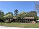 Charming brick home with lush landscaping and flowering trees in the front yard at 3557 Clubhouse Ln, Conyers, GA 30094