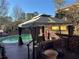 Outdoor pool with gazebo and lounge seating on a wood deck at 3557 Clubhouse Ln, Conyers, GA 30094