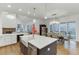 Modern kitchen with large island, white cabinets, and a farmhouse sink at 4964 Brendlynn Dr, Suwanee, GA 30024