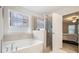 Spa-like bathroom featuring a soaking tub and shower at 7787 Richmond Trl, Fairburn, GA 30213