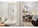 Small bathroom with single sink vanity and view into living room at 7787 Richmond Trl, Fairburn, GA 30213