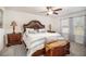 Main bedroom with plush carpet, large bed, and ceiling fan at 7787 Richmond Trl, Fairburn, GA 30213