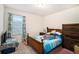 Bright bedroom with a double bed and wood dresser at 7787 Richmond Trl, Fairburn, GA 30213