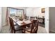 Dining room with a wood table and chairs, and access to the entryway at 7787 Richmond Trl, Fairburn, GA 30213