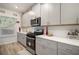 Modern kitchen with gray cabinets, white countertops and stainless steel appliances at 7787 Richmond Trl, Fairburn, GA 30213