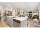 Open kitchen boasts modern gray cabinets, white countertops, and stainless steel appliances at 7787 Richmond Trl, Fairburn, GA 30213